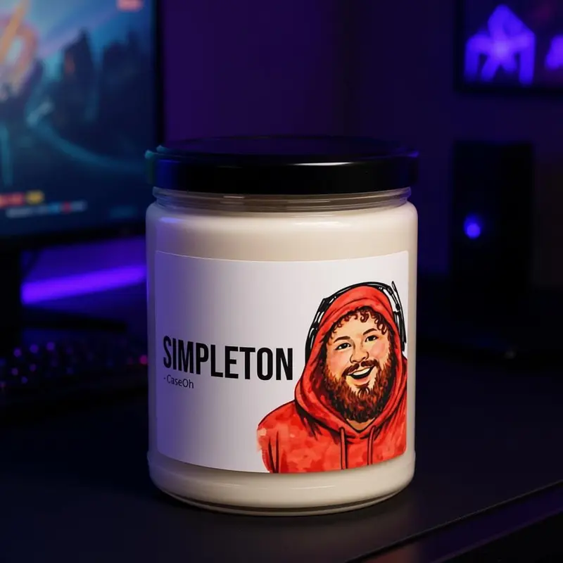 The Simpleton candle, a white jar with a meme label.